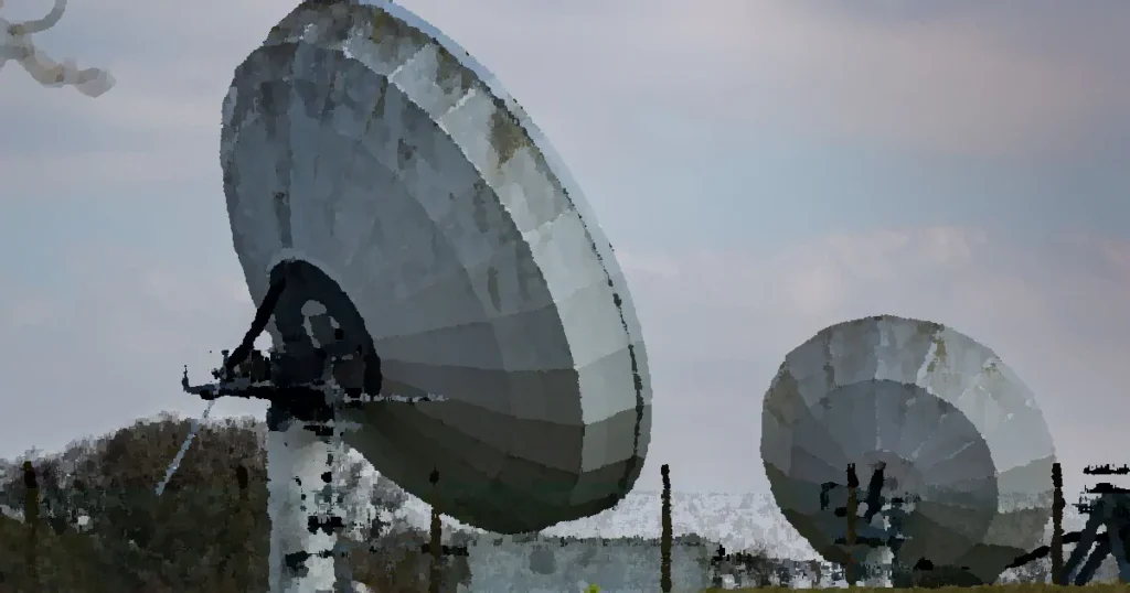 Two large radio telescopes in an outdoor setting, showcasing astronomy and science technology.