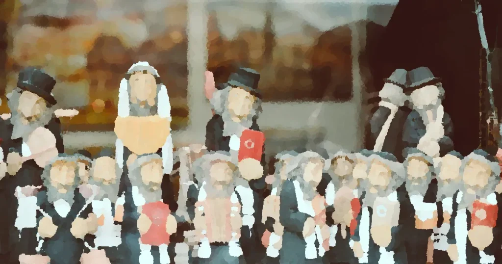 Display of traditional Jewish figurines in a Prague store window, showcasing cultural craftsmanship.