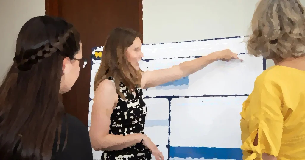 Researcher explaining cognitive science poster to peers, emphasizing scientific collaboration.
