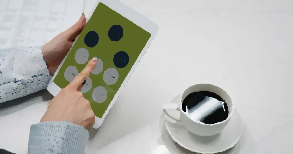 Hands holding a tablet with a diagram, next to a cup of black coffee on a desk, symbolizing modern work life.