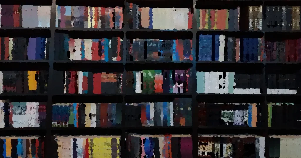 Diverse collection of books on a library shelf in Dhaka, Bangladesh.