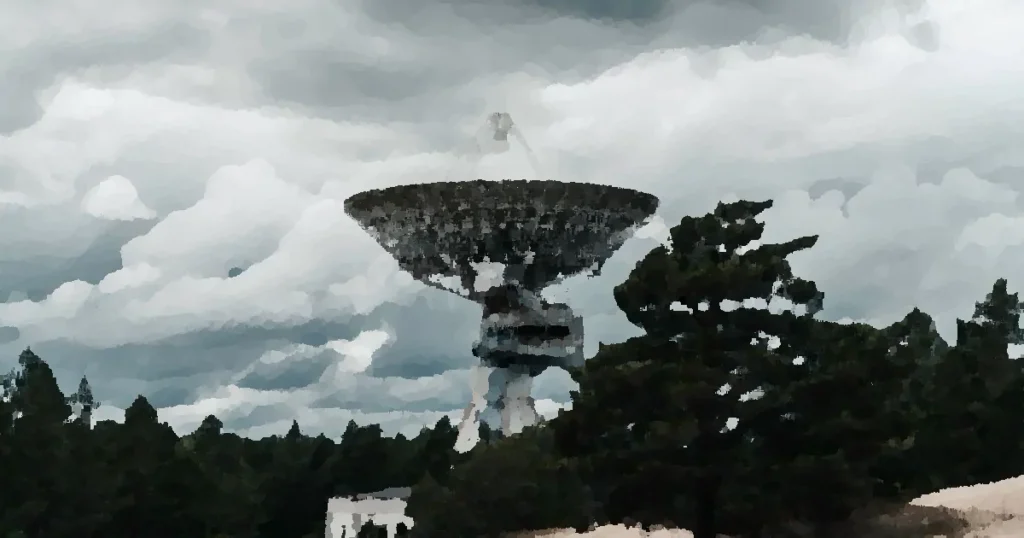 A large radio telescope tower stands in a forest under dramatic clouds, showcasing space technology.