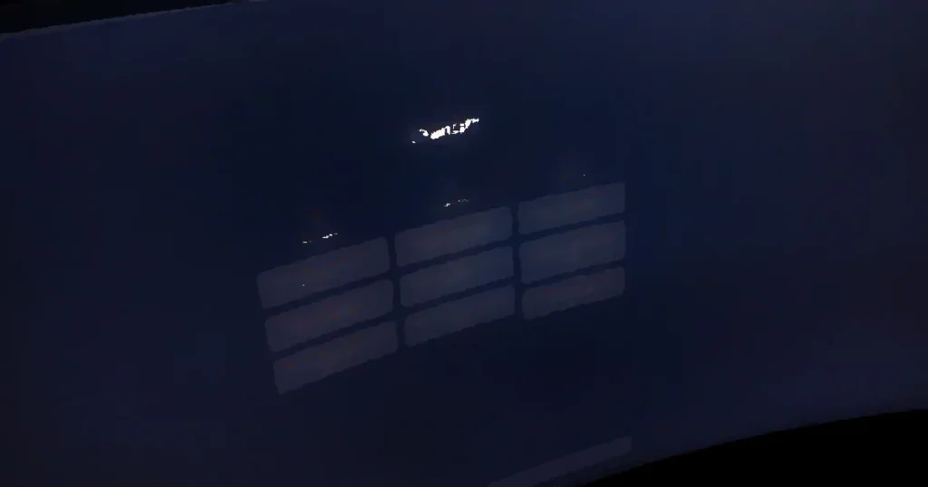 Close-up of a computer screen displaying ChatGPT interface in a dark setting.