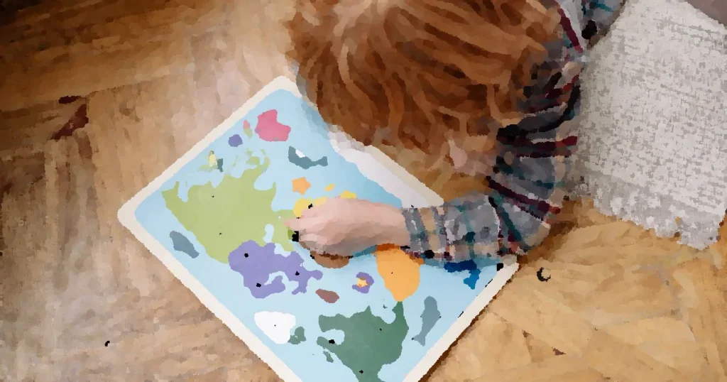 A child engaged with a colorful educational world map puzzle on a wooden floor, enhancing their problem-solving skills.