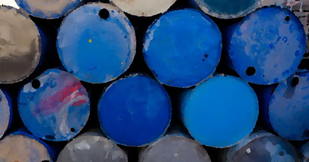 A collection of blue metal drums stacked outdoors, highlighting industrial recycling.