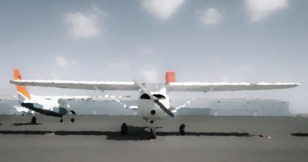 Modern tricycle gear civil utility aircraft with propeller parked on airfield in aerodrome against cloudy blue sky